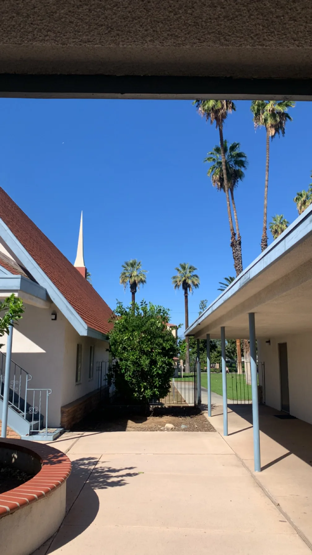 A shaded walkway leading through a courtyard